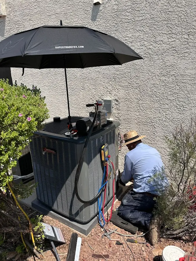 HVAC technician performing outdoor AC maintenance in Arroyo Grande